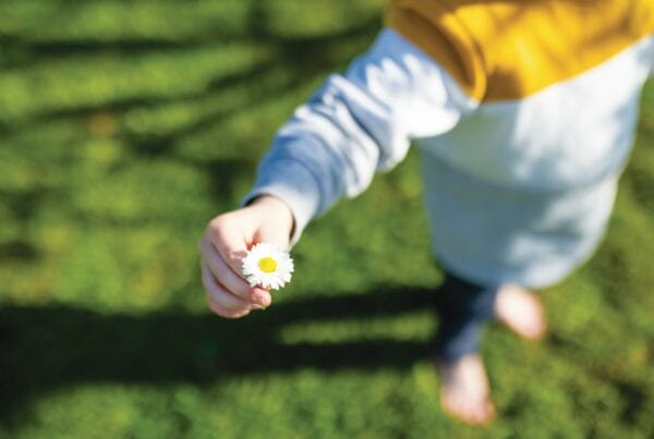 kid holding flower