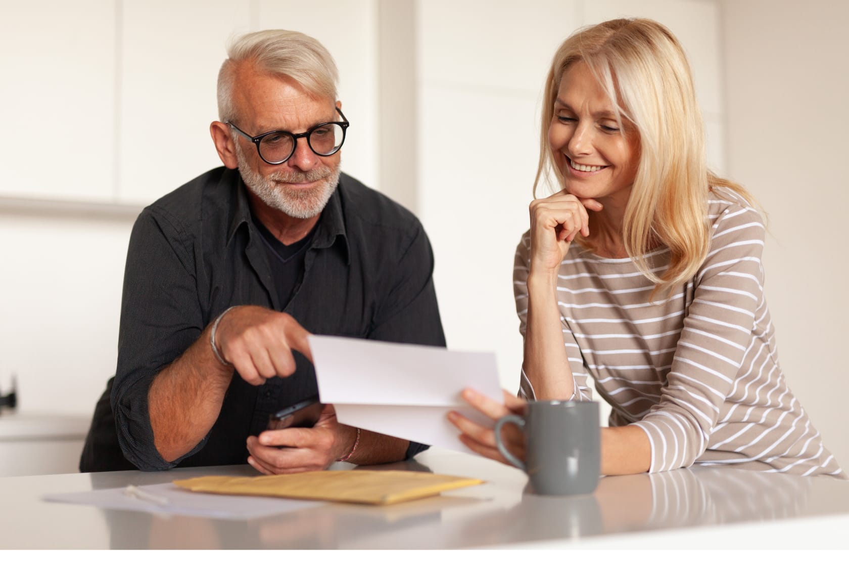 seated man & woman looking at a document